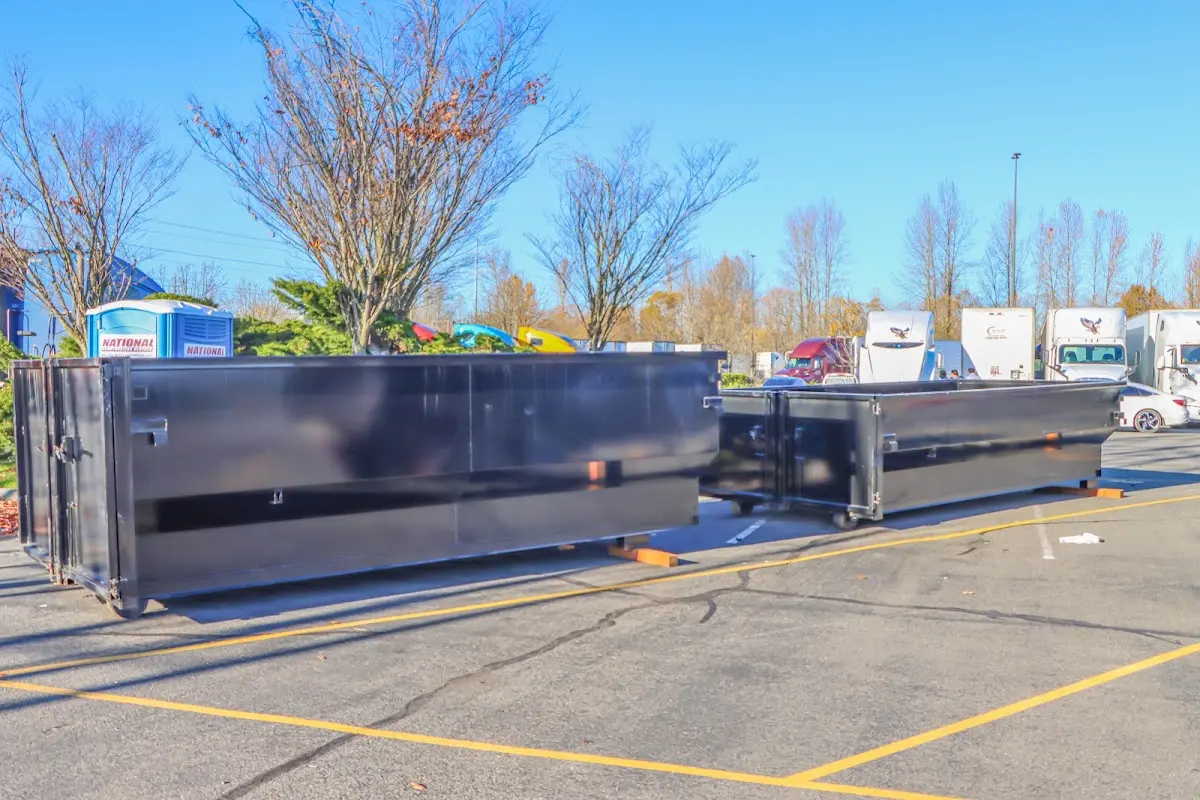 Professional dumpster rental service with roll-off container on residential driveway in West Plains